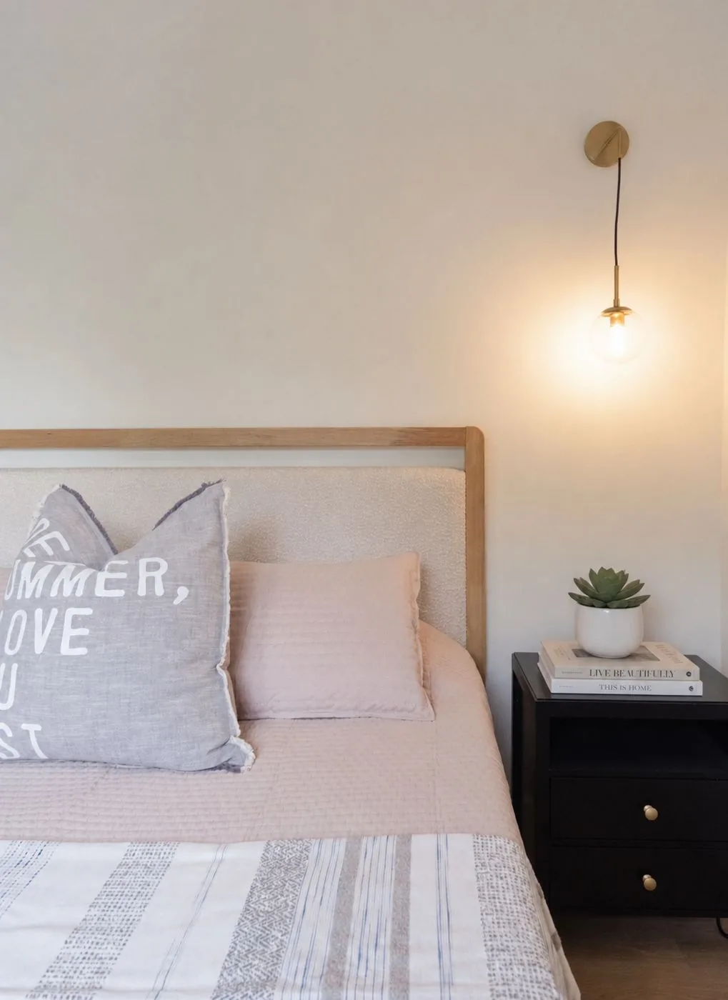 Bedroom detail with brass sconce