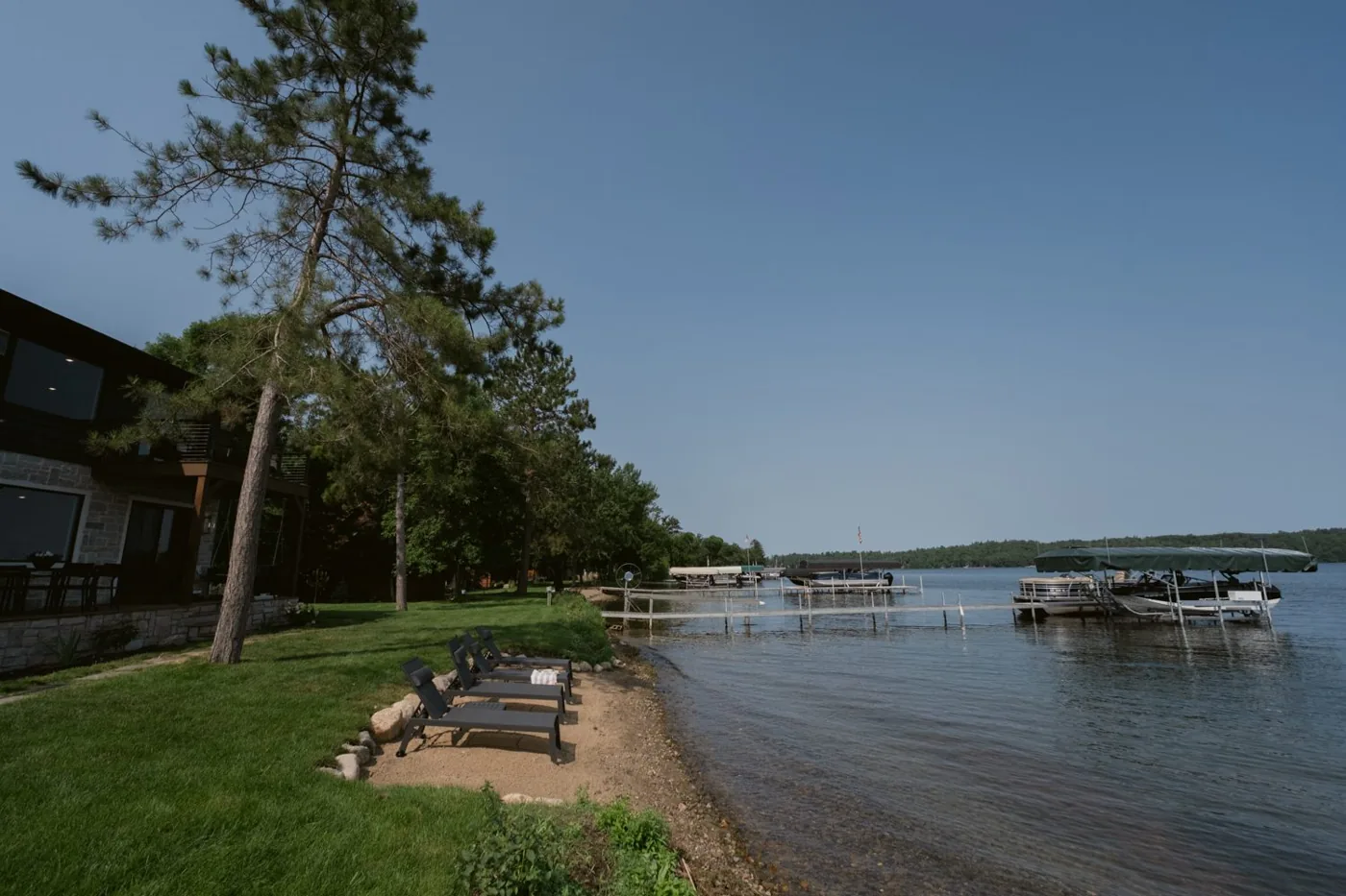 Flat sandy beach with loungers at the water's edge