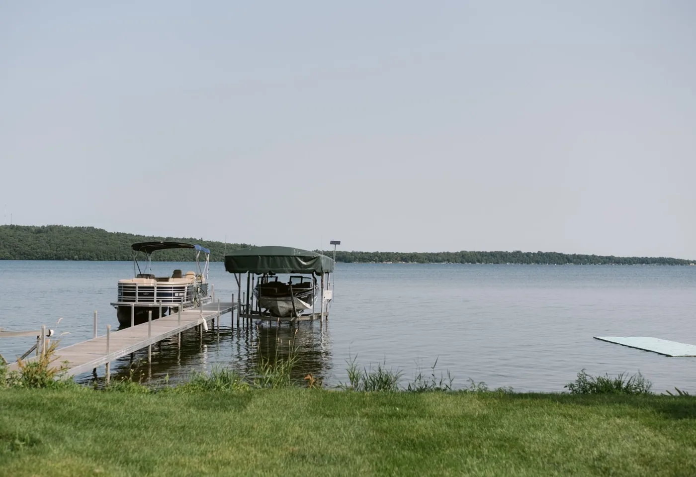 Private dock with pontoon and fishing boat