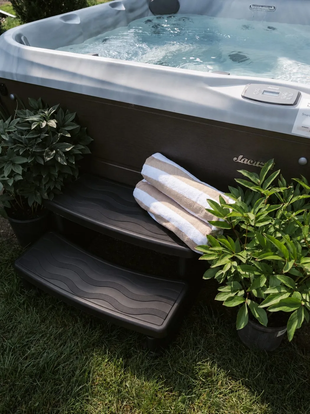 Hot tub with towels and greenery