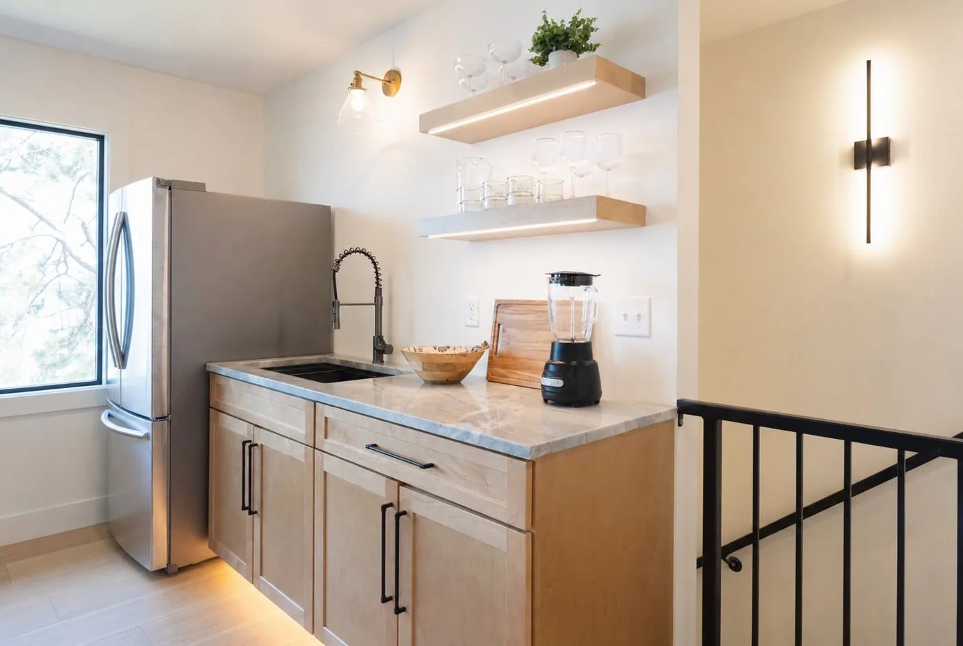 Wet bar with marble counter and open shelving
