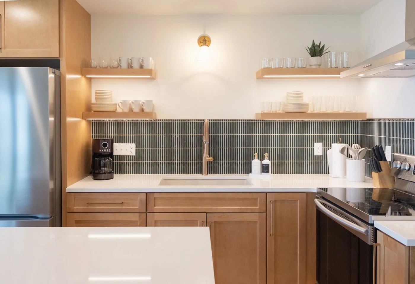 Kitchen with green tile backsplash and open shelving